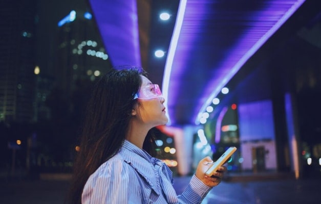 person holding phone looking up