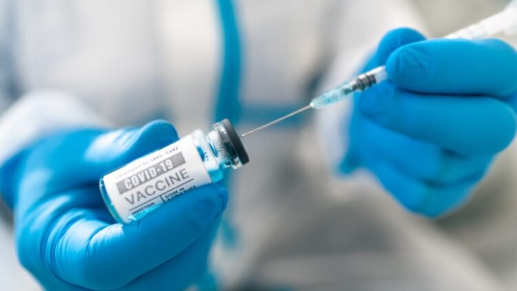 injecting needle into the medicine bottle