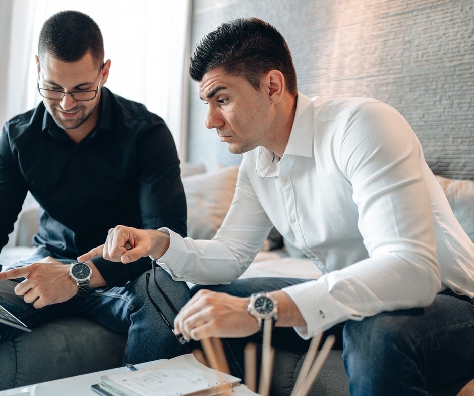 2 men looking at a tablet