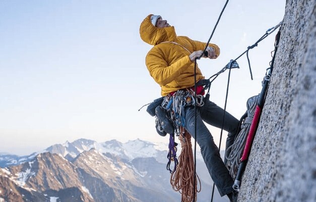 rock climber looking up mountain