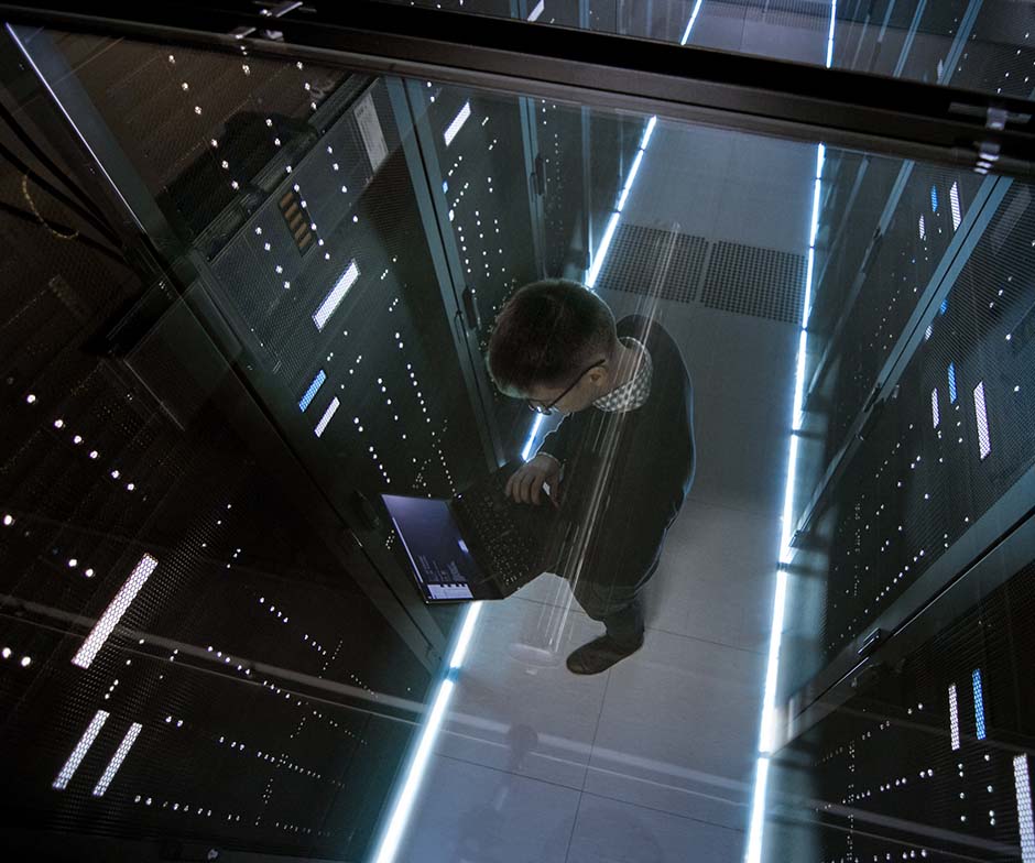 Personne travaillant avec un ordinateur portable dans un data center