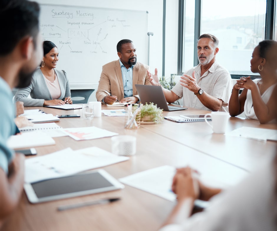 team members sitting inside conference room and discussing