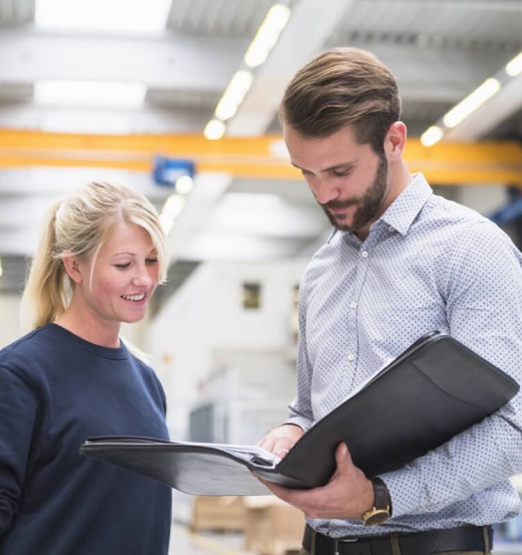Two STRAMA employees reviewing a file
