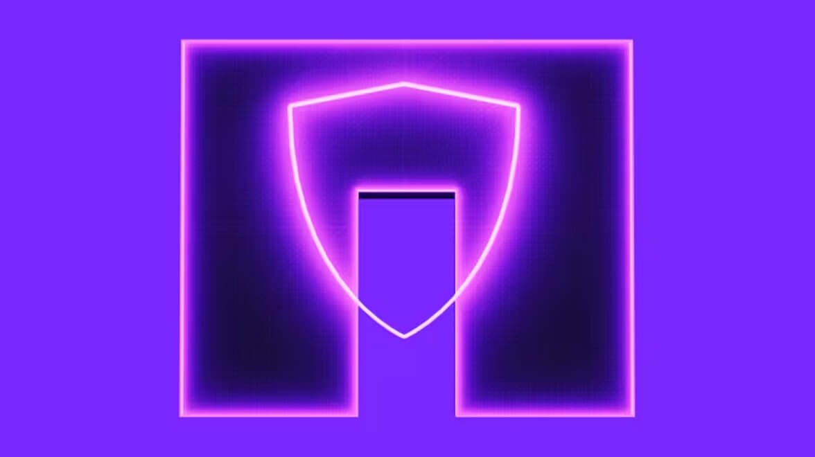 Gráfico digital de escudo colorido iluminado por néon representando cibersegurança e proteção de dados.