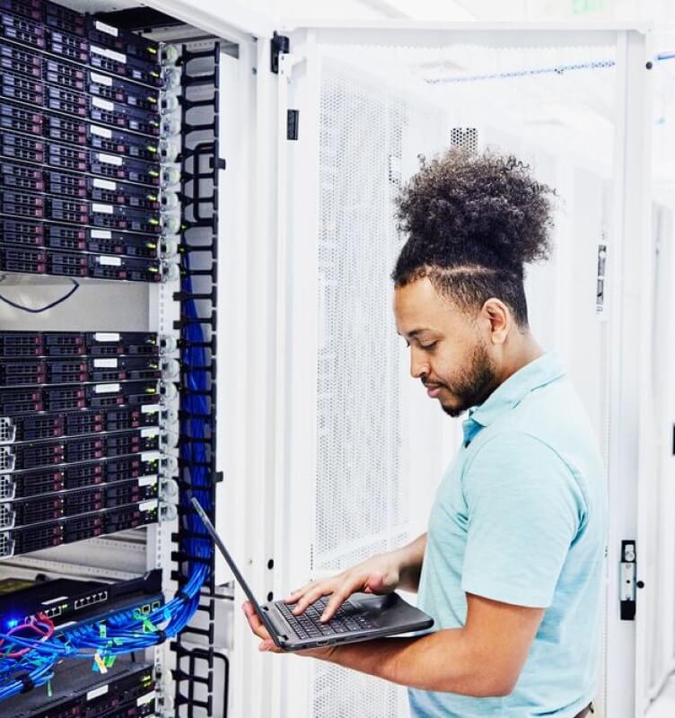 person looking at monitor analyzing data inside data server