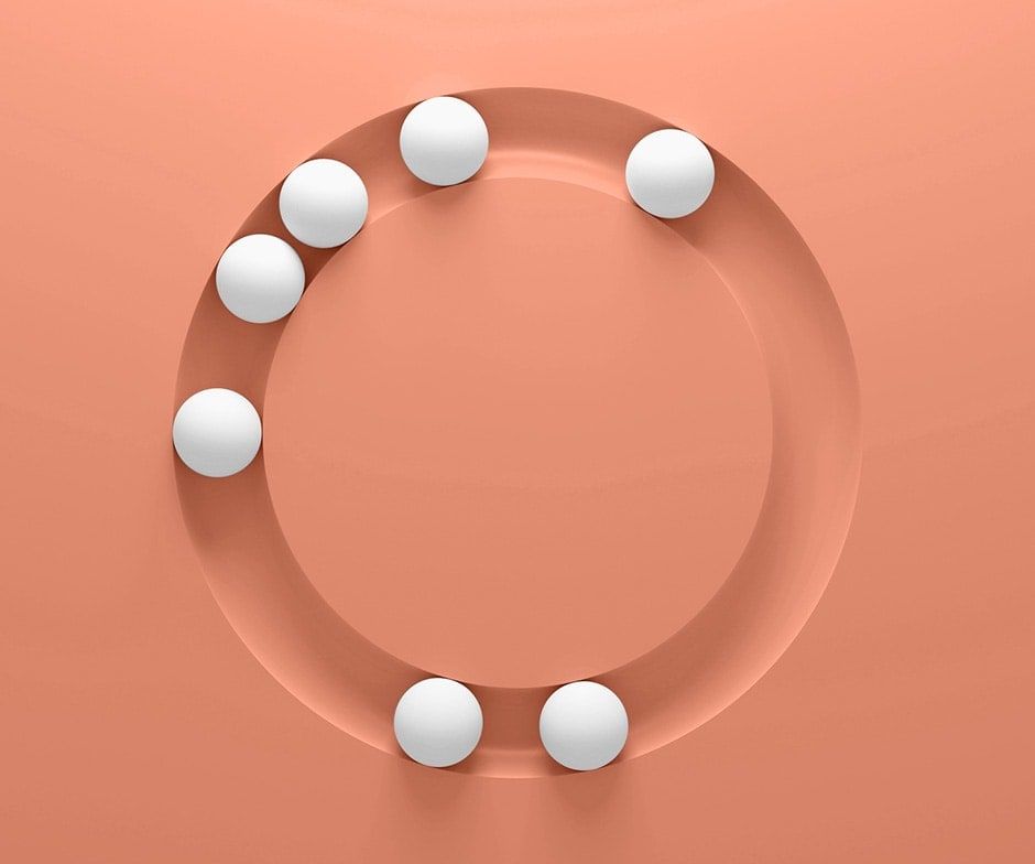 White spheres in an orange circle on an orange background