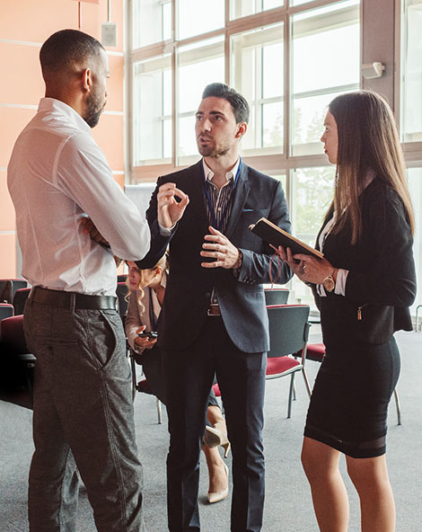 Three people standing and talking
