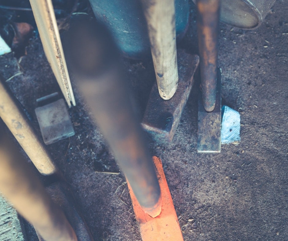 different color of sledge hammers from vertical view lowered on sand
