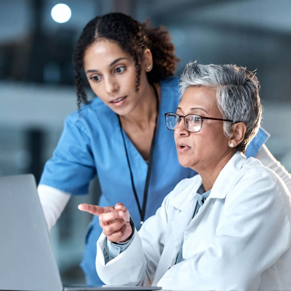 healthcare workers looking at technology