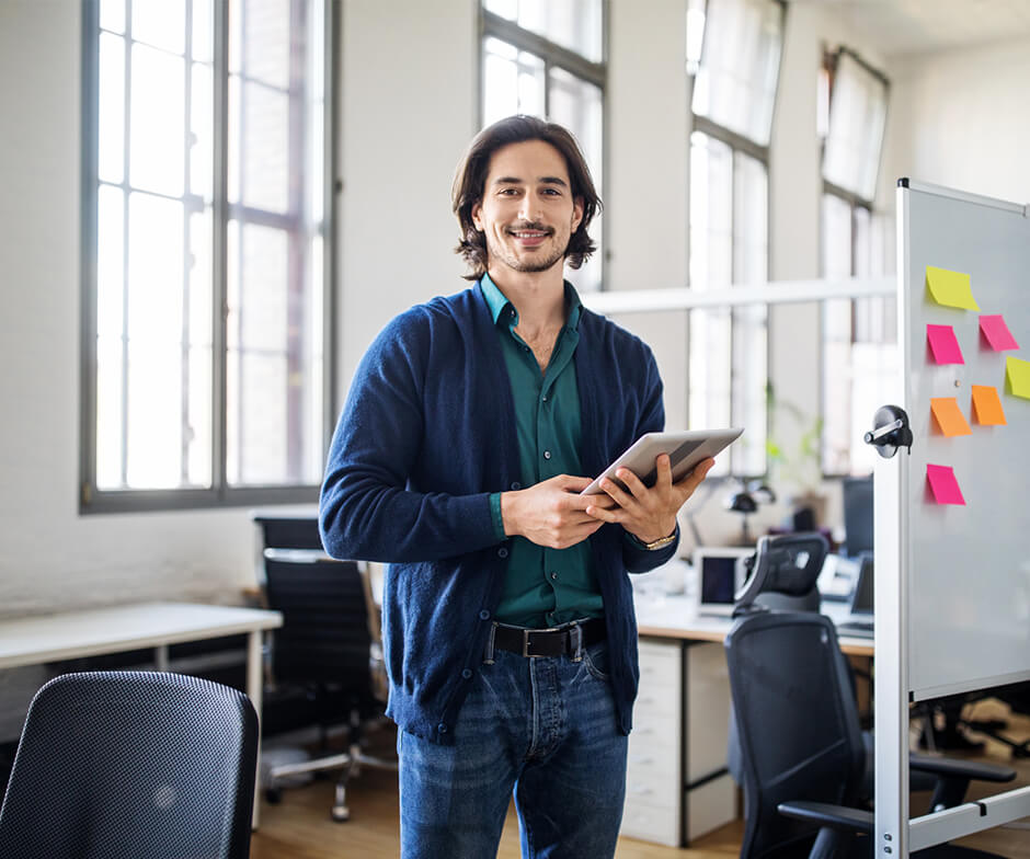 Smiling professional holding tablet