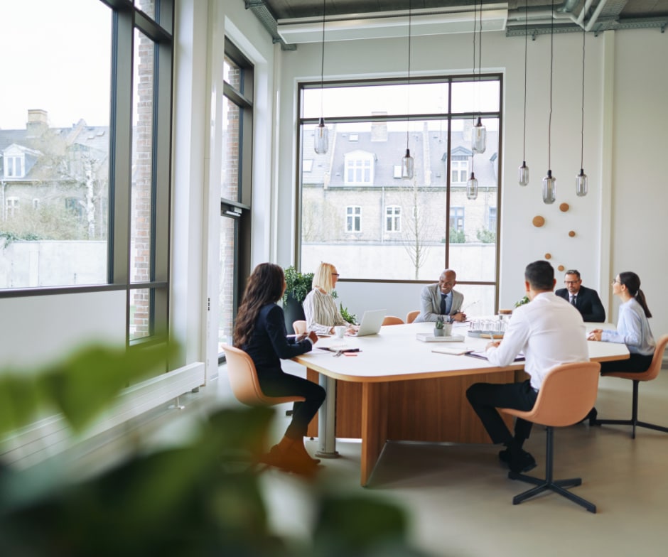 group of people sitting in conference room and discussing