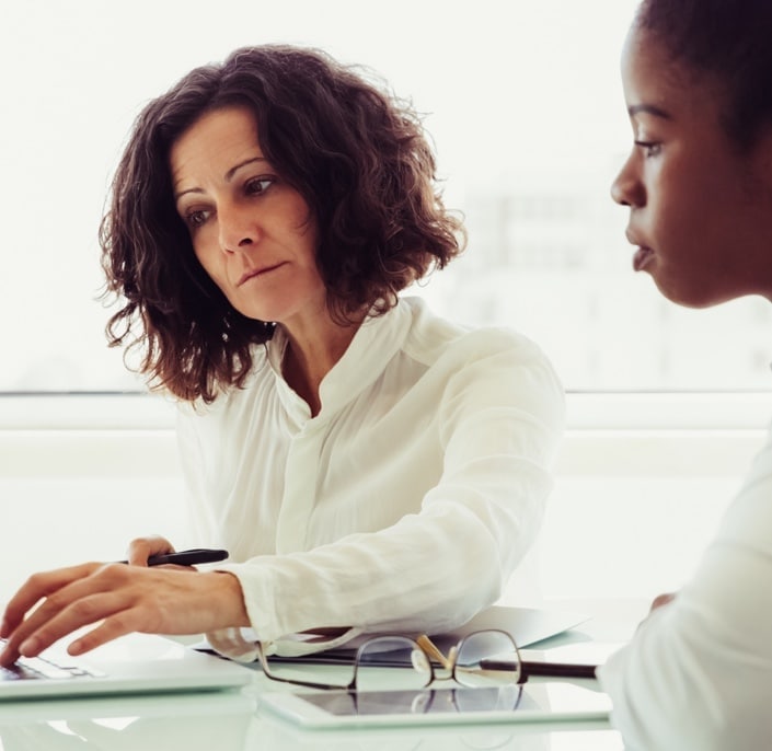 two people working together at a computer
