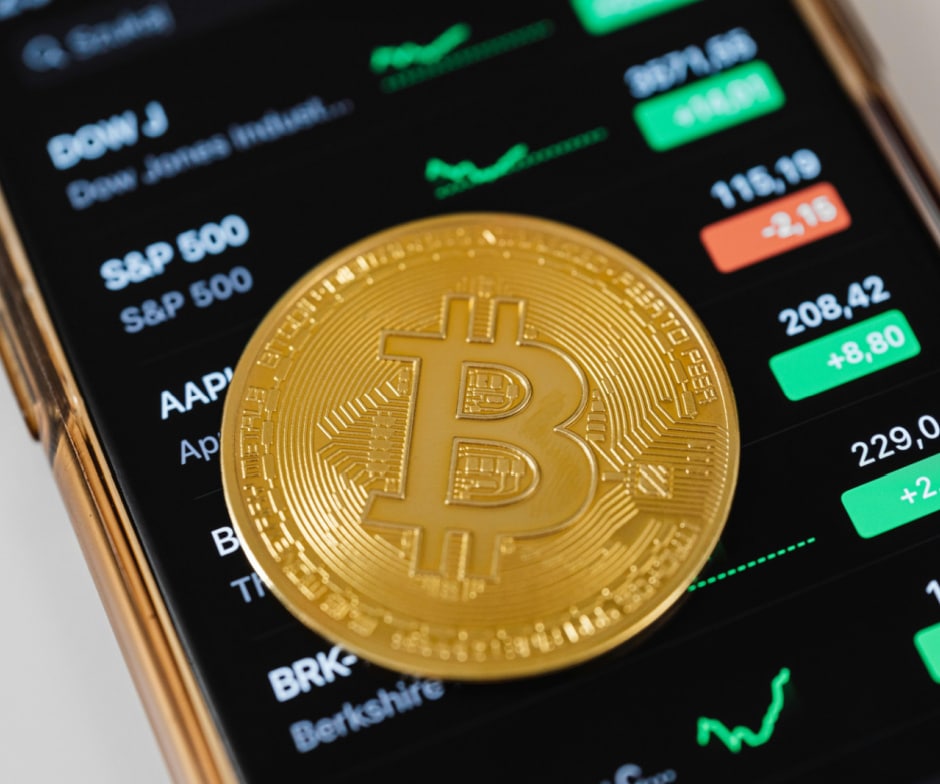 gold bitcoin on top of stock market screen
