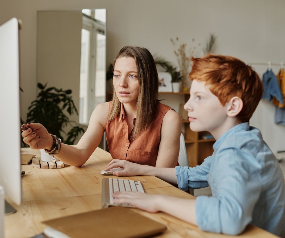 boy and woman working together at a computer