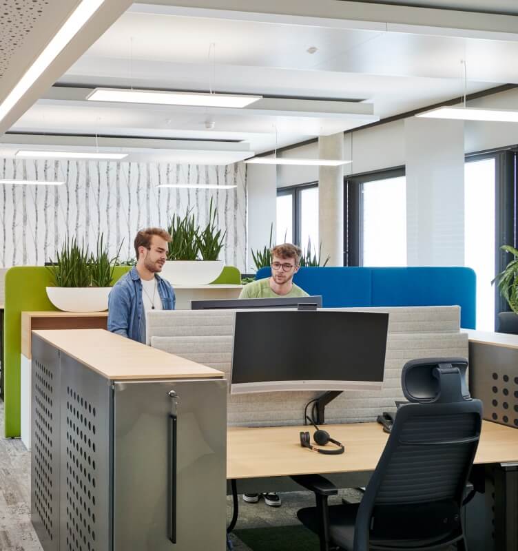 Two employees at a workstation
