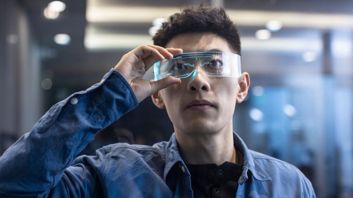 Man looking at screen through glasses