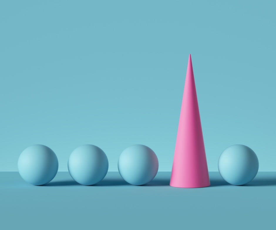 blue background with 4 blue spheres horizontally aligned and a pink cone nestled between the 3rd and 4th sphere