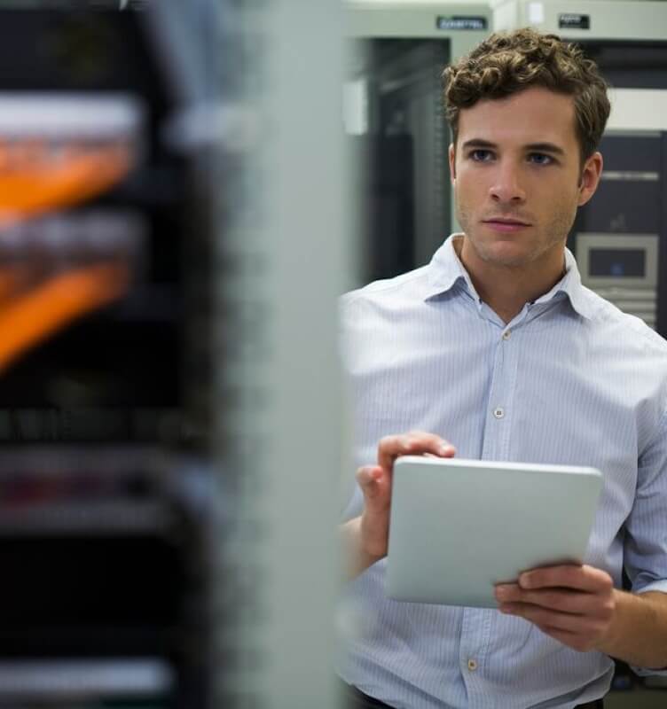 person taking notes inside data server room