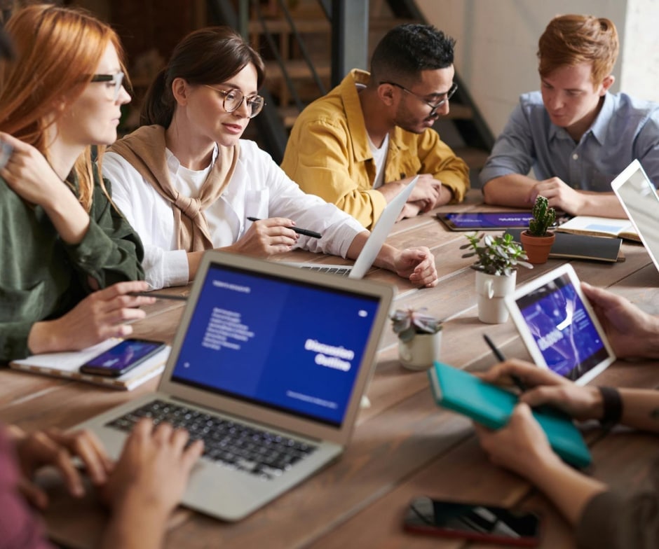 Group of people working together with laptops