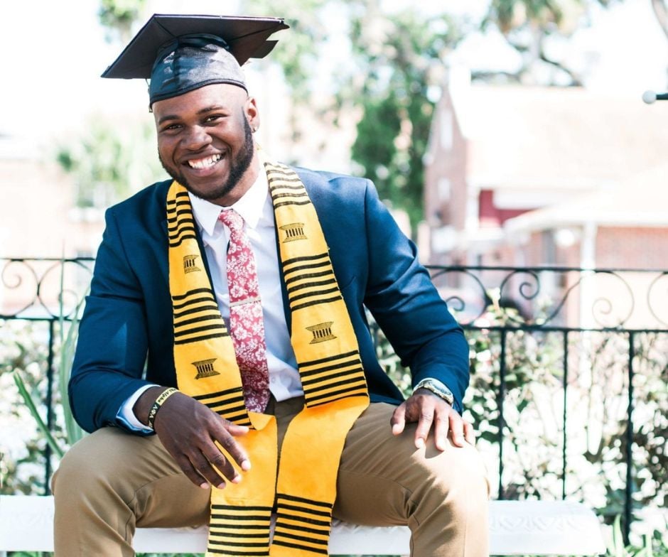 person graduated form university sitting and posing for photo