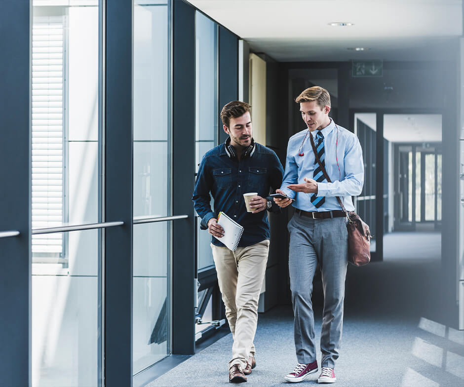 Two professionals walking and chatting
