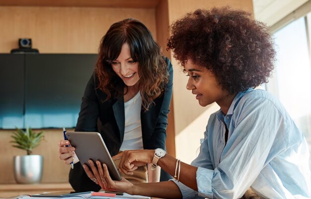 two professionals looking at tablet