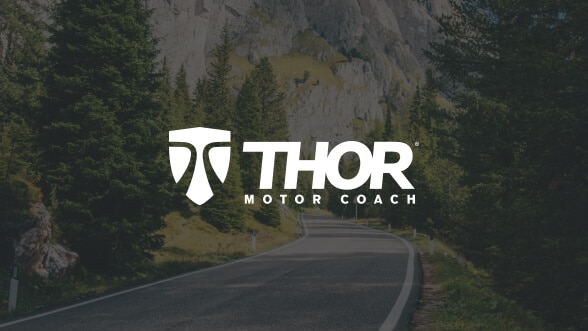 Thor Motor Coach logo over an image of a winding mountain road.