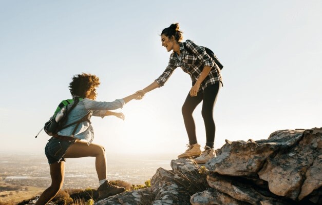 A hiker giving a helping hand to another hiker