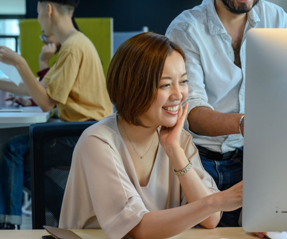 A Person looking at the monitor with a smiling face