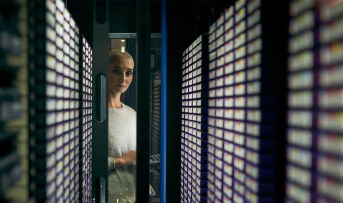 woman looking at a server rack